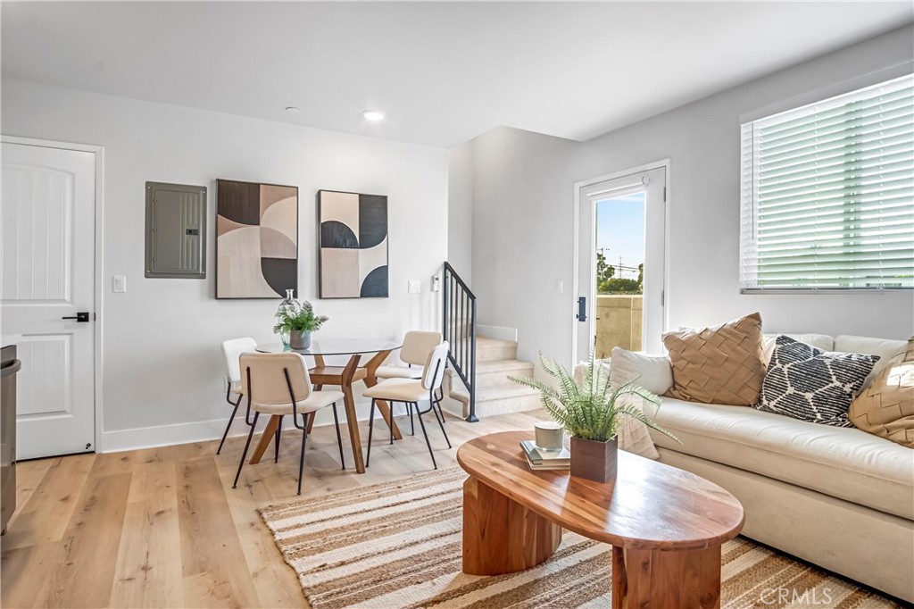 10035 South Western Avenue, Unit 101 Los Angeles, CA 90047 - Photo 5 of 22 a living room with furniture and wooden floor