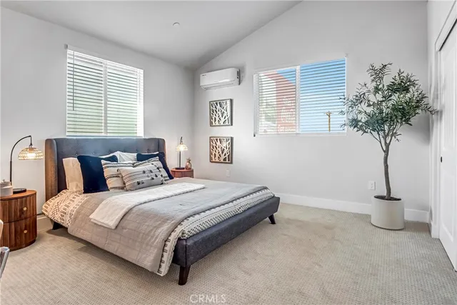 a bedroom with a bed and a potted plant