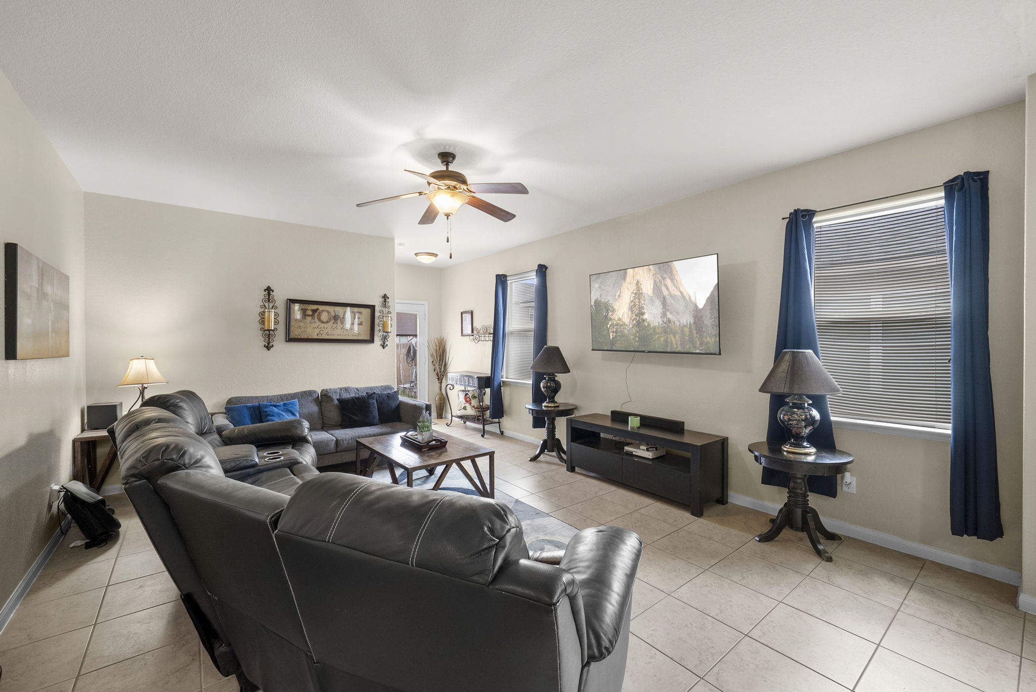 1617 Treeta Trail Kyle, TX 78640 - Photo 26 of 39 Living area with light tile patterned floors and ceiling fan