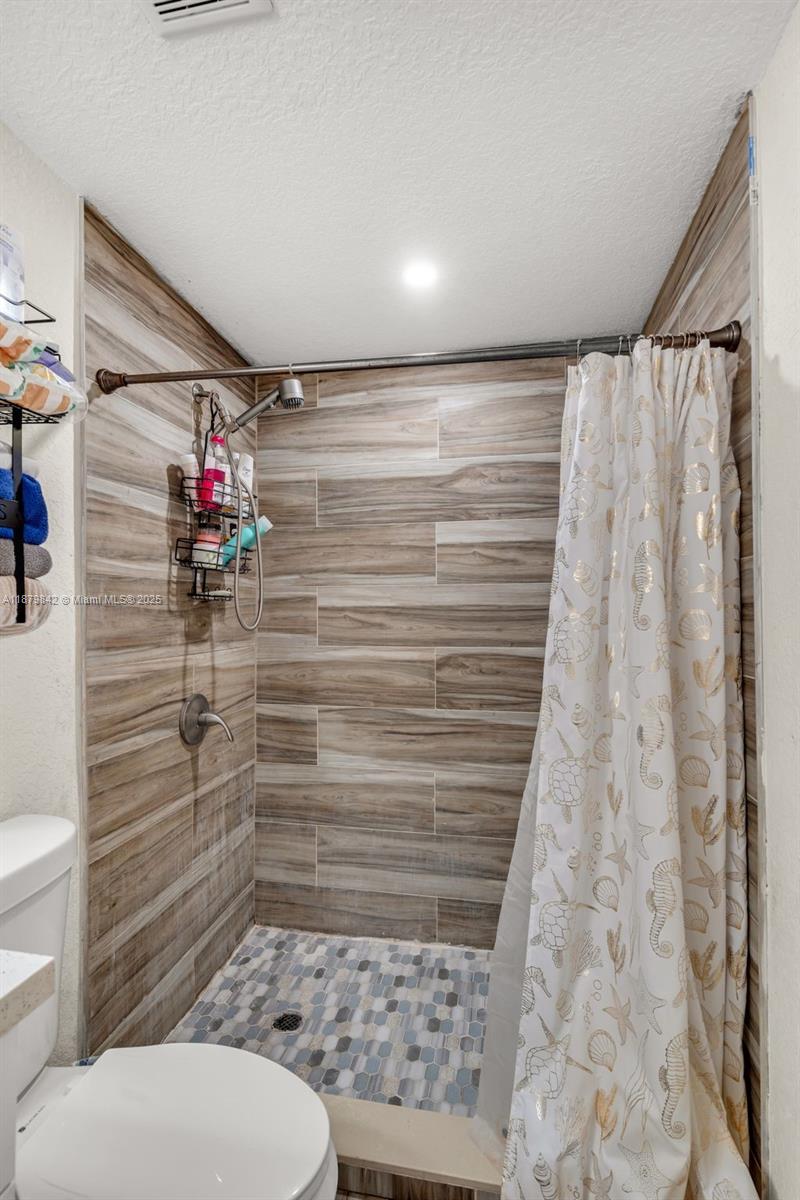 114 Marion Road West Park, FL 33023 - Photo 15 of 24 a bathroom with a toilet and a shower