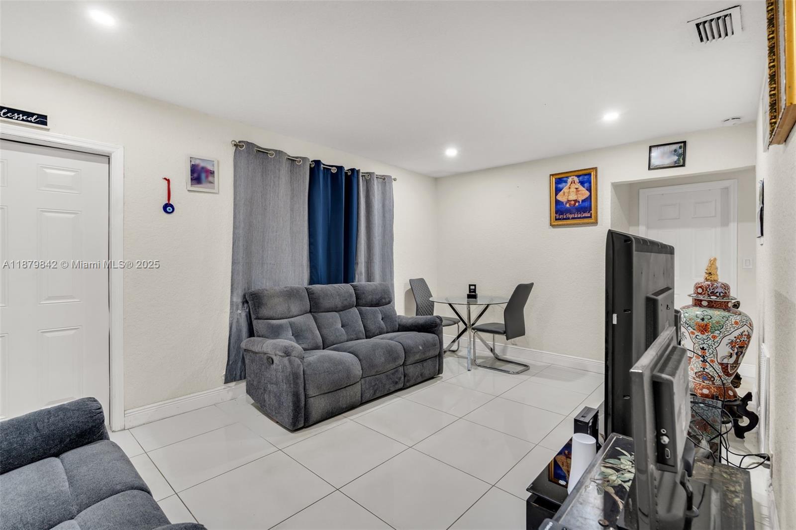 114 Marion Road West Park, FL 33023 - Photo 6 of 24 a living room with furniture and a flat screen tv