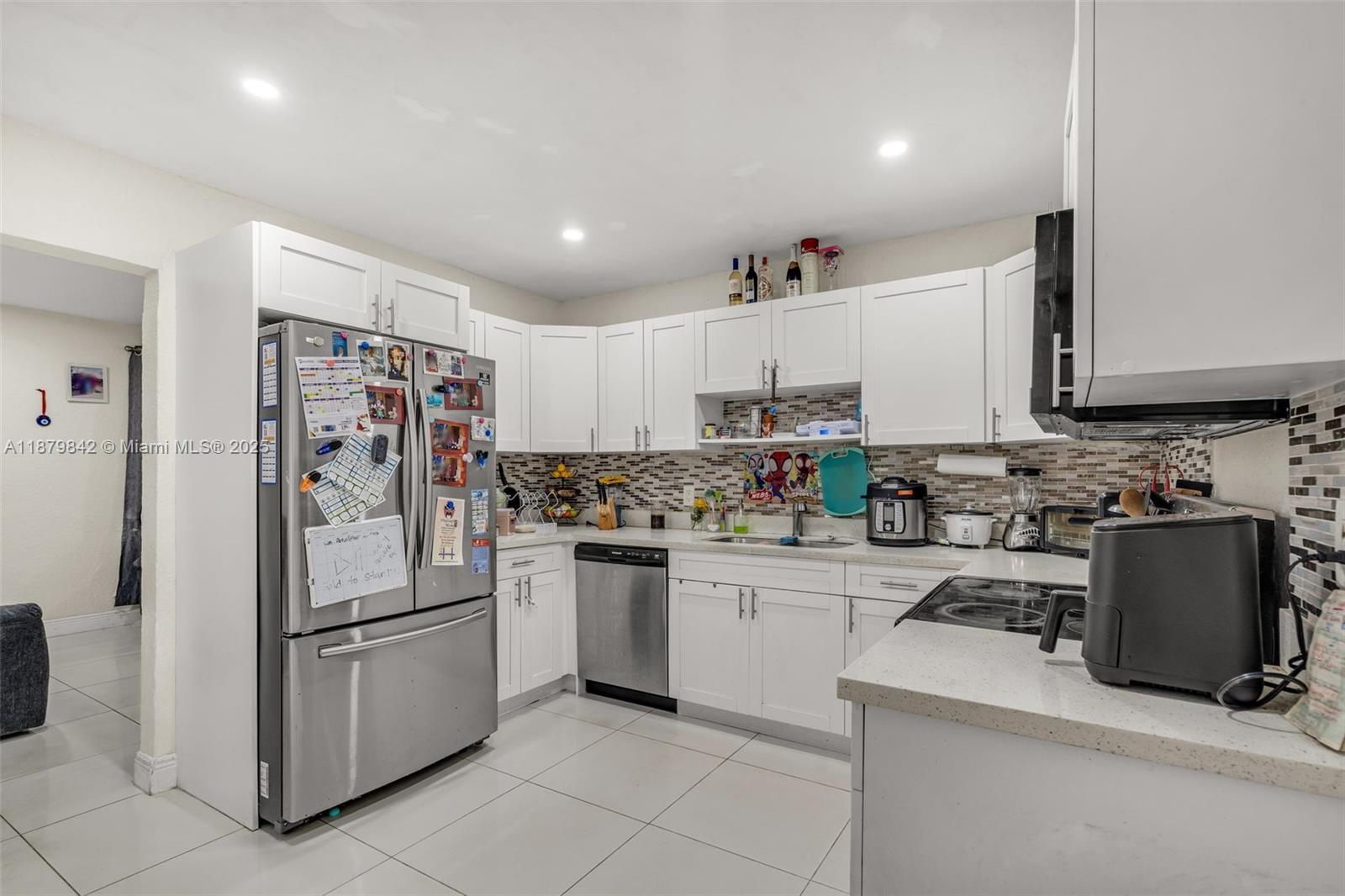 114 Marion Road West Park, FL 33023 - Photo 8 of 24 a kitchen with a sink a refrigerator and cabinets