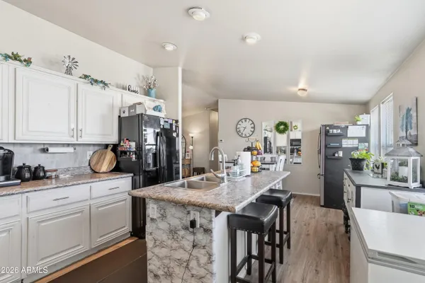 a kitchen with granite countertop a white cabinets and window