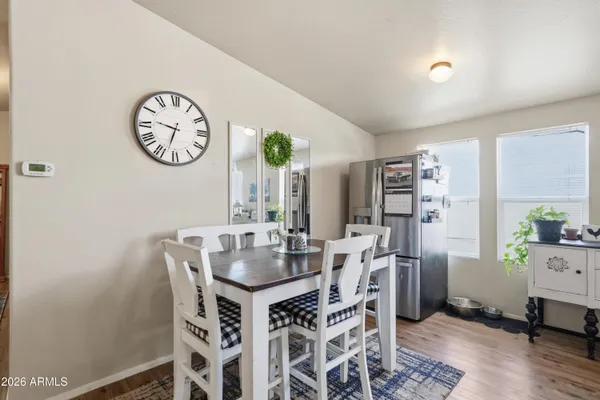 a view of a dining room with furniture and a large window
