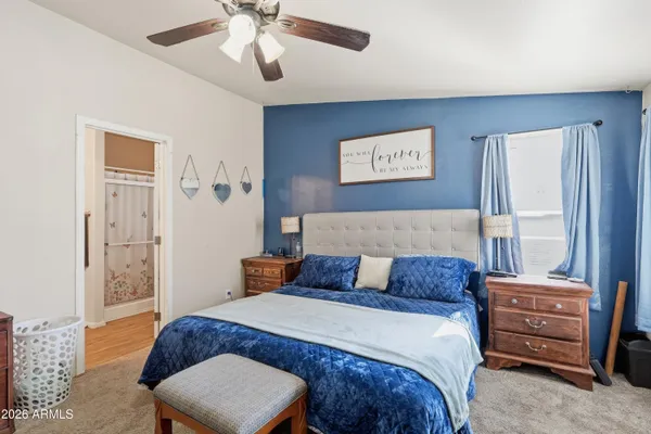 a bedroom with a bed window and a chandelier