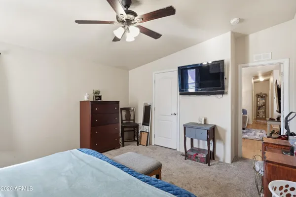 a bedroom with a bed and a television