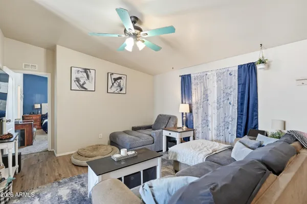 a living room with furniture and wooden floor