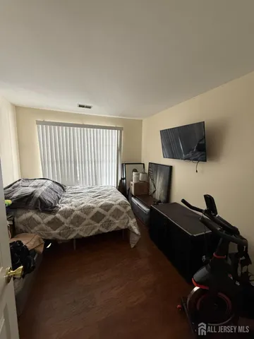 a bedroom with a bed and a tv