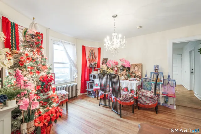 a view of a dining room with furniture and chandelier