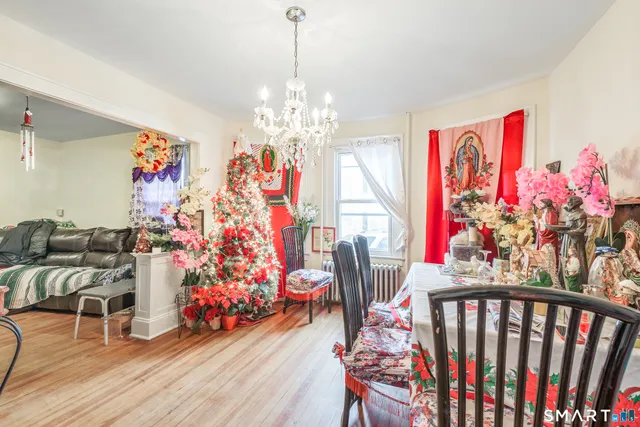 a living room with furniture and a chandelier