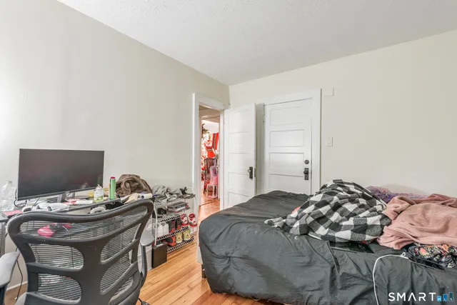 a bedroom with a bed and a flat screen tv