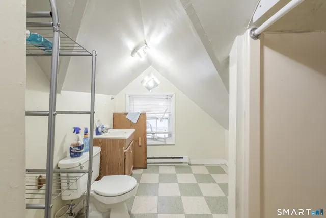 a bathroom with a toilet a sink and a mirror