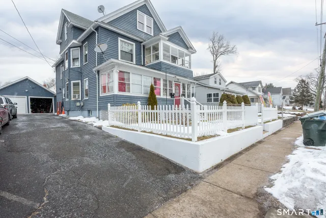 a view of building with large windows and a small yard