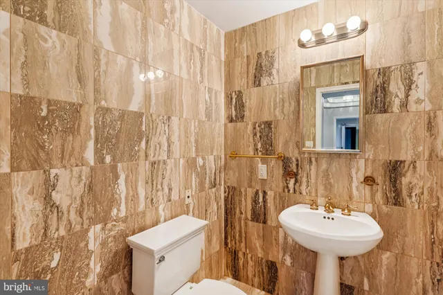 a bathroom with a sink a mirror and a toilet