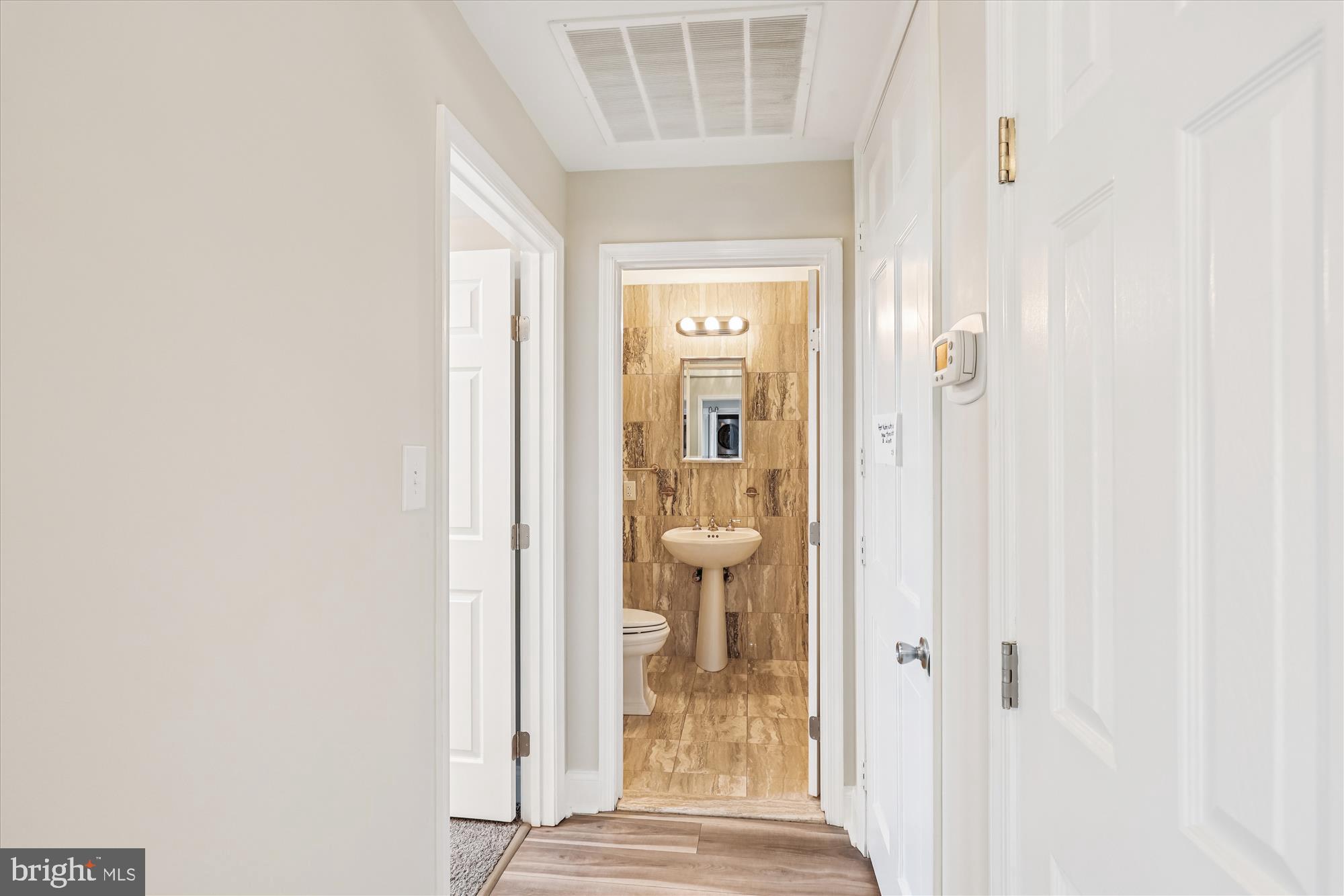 3801 Canterbury Road, Unit 404 Baltimore, MD 21218 - Photo 27 of 37 a view of a bathroom from a hallway