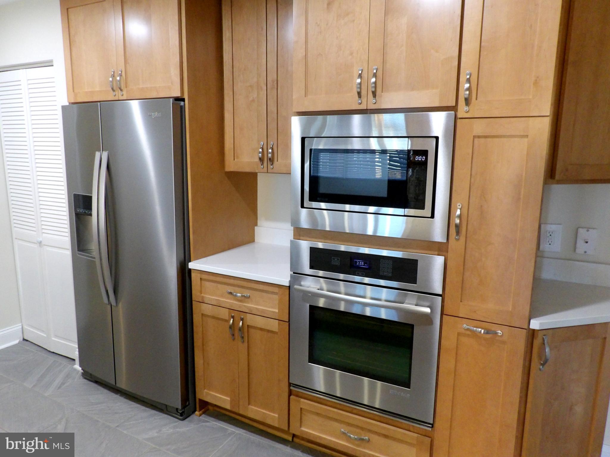 3801 Canterbury Road, Unit 404 Baltimore, MD 21218 - Photo 3 of 37 a kitchen with stainless steel appliances a refrigerator stove and microwave