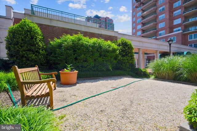 a view of a chairs and table in backyard of house