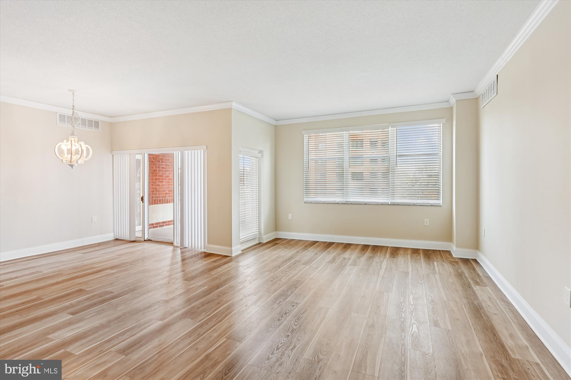 3801 Canterbury Road, Unit 404 Baltimore, MD 21218 - Photo 6 of 37 an empty room with wooden floor and windows