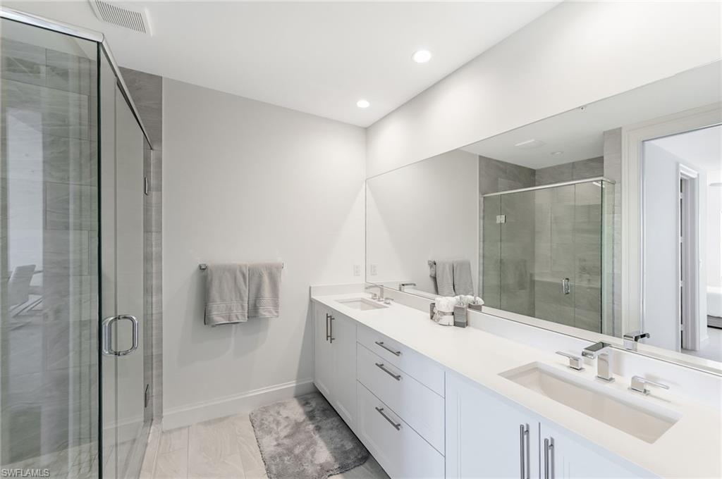 1111 Central, Unit 417S Naples, FL 34104 - Photo 14 of 25 a bathroom with a double vanity sink mirror and double