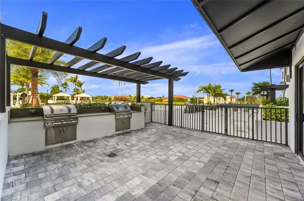 a living room with furniture large windows and a flat screen tv