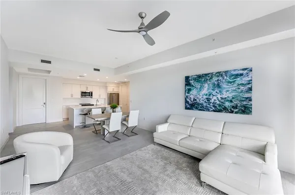 a large white kitchen with a large window