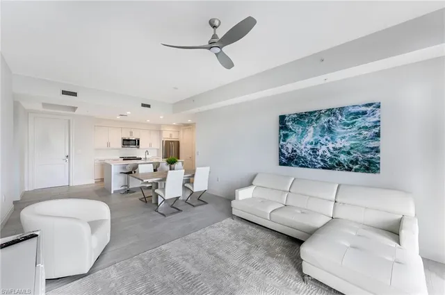 a large white kitchen with a large window