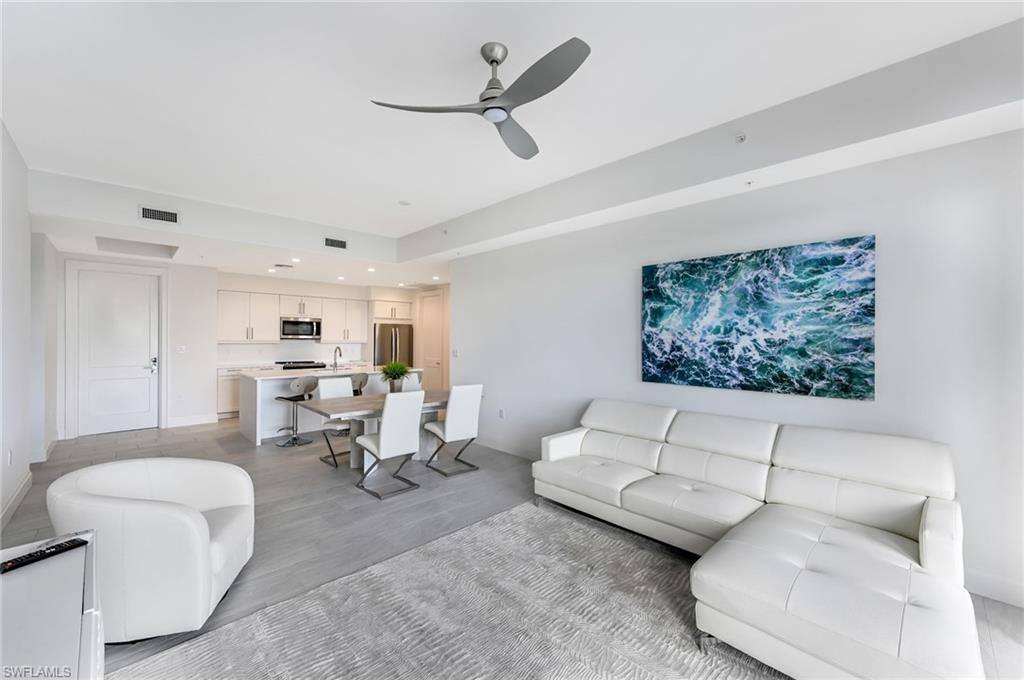 1111 Central, Unit 417S Naples, FL 34104 - Photo 7 of 25 a living room with furniture and a rug
