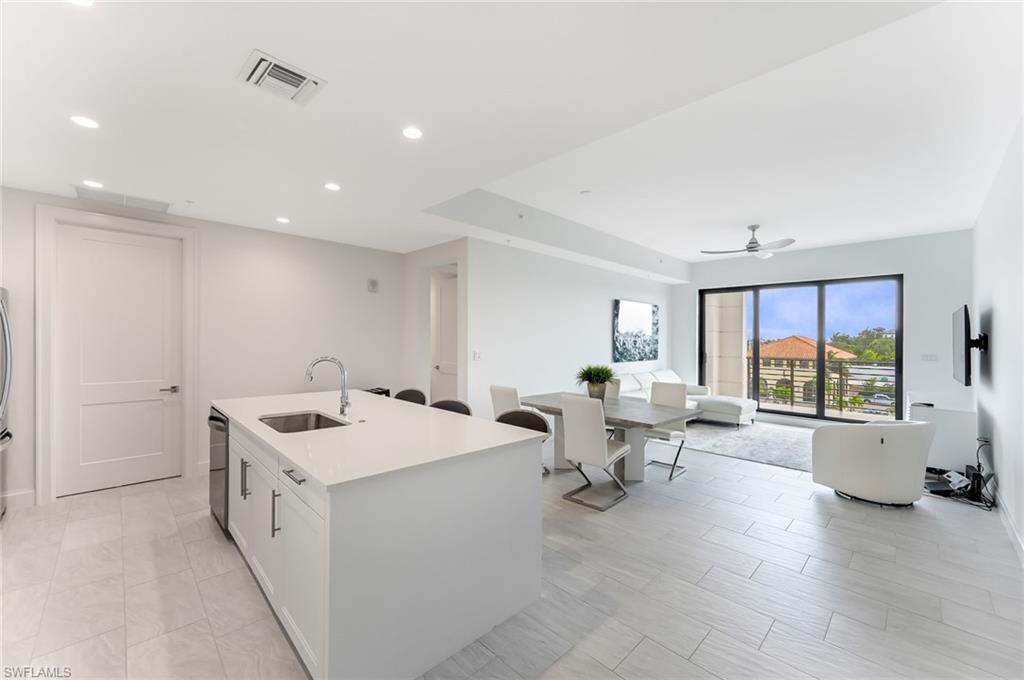1111 Central, Unit 417S Naples, FL 34104 - Photo 8 of 25 a large white kitchen with a large window