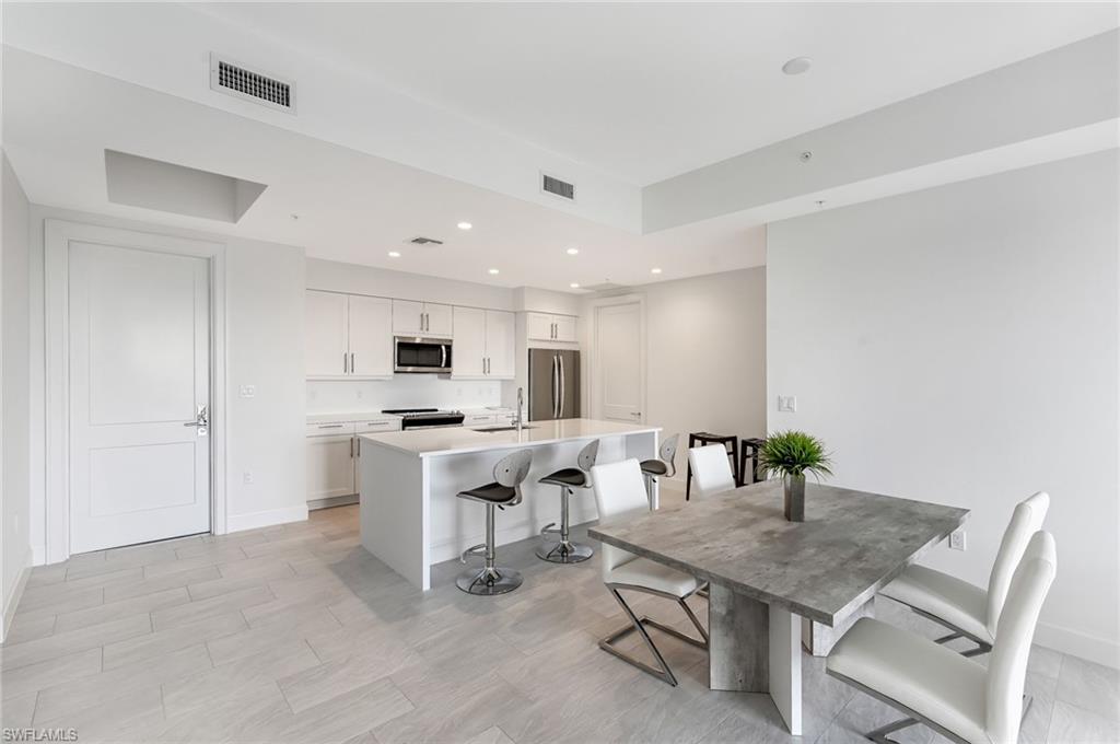 1111 Central, Unit 417S Naples, FL 34104 - Photo 10 of 25 a view of a dining room with furniture