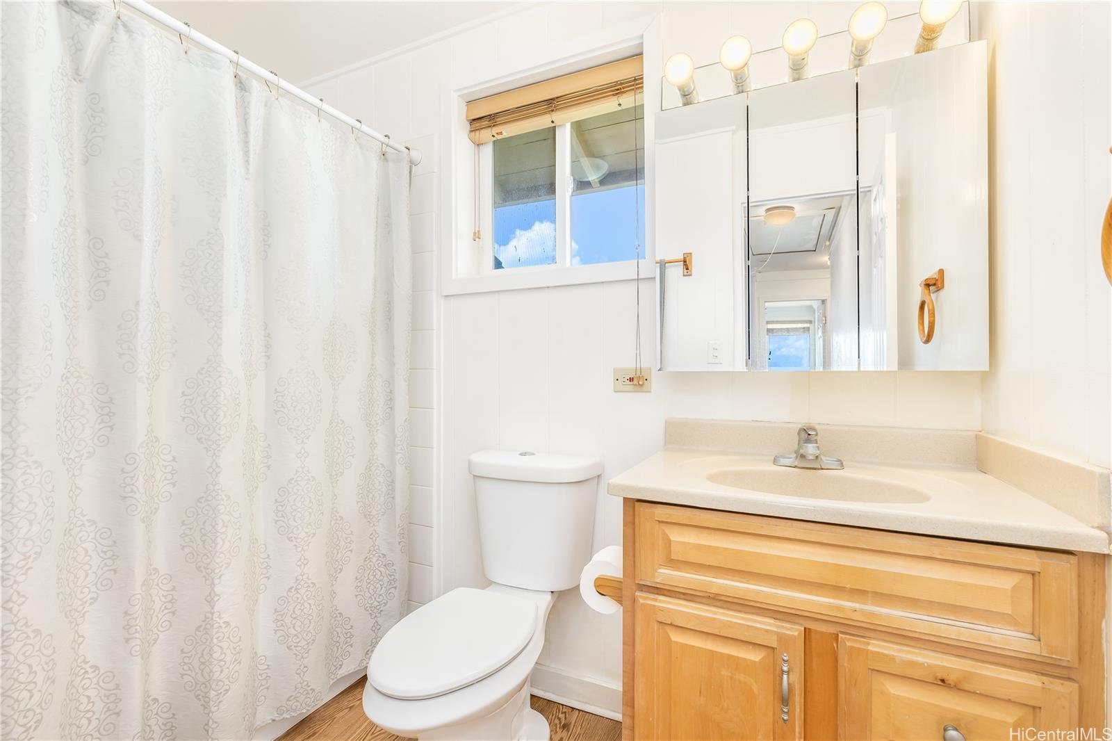 92-787 Makakilo Drive, Unit D28 Kapolei, HI 96707 - Photo 11 of 23 a bathroom with a sink a toilet and a mirror