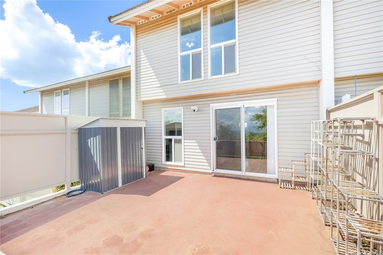 92-787 Makakilo Drive, Unit D28 Kapolei, HI 96707 - Photo 15 of 23 a view of a house with a patio and wooden fence