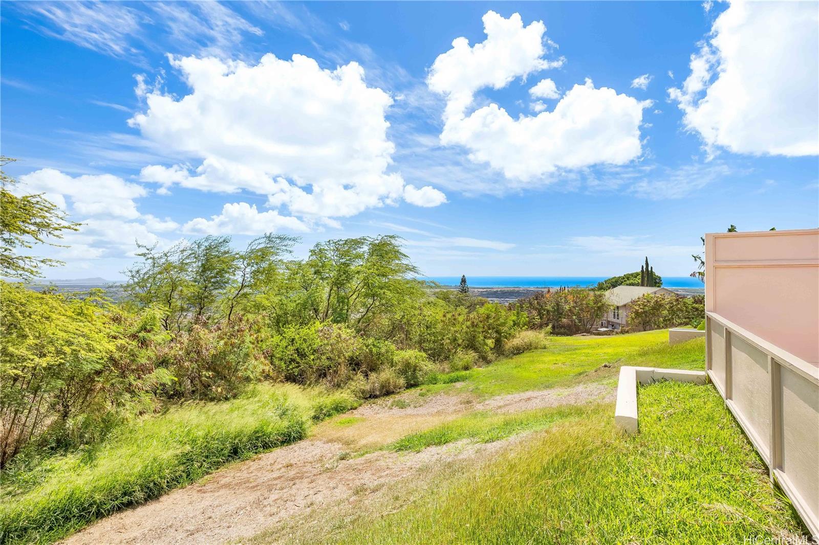 92-787 Makakilo Drive, Unit D28 Kapolei, HI 96707 - Photo 16 of 23 a view of a pathway both side of green field with tree in back
