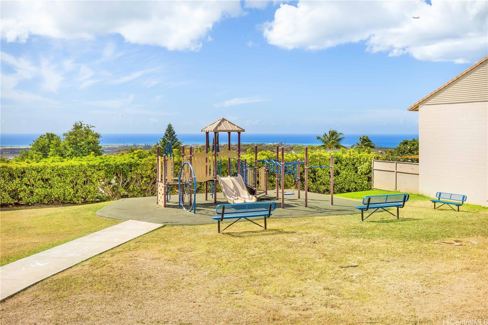 92-787 Makakilo Drive, Unit D28 Kapolei, HI 96707 - Photo 20 of 23 a view of swimming pool with lawn chairs and a yard