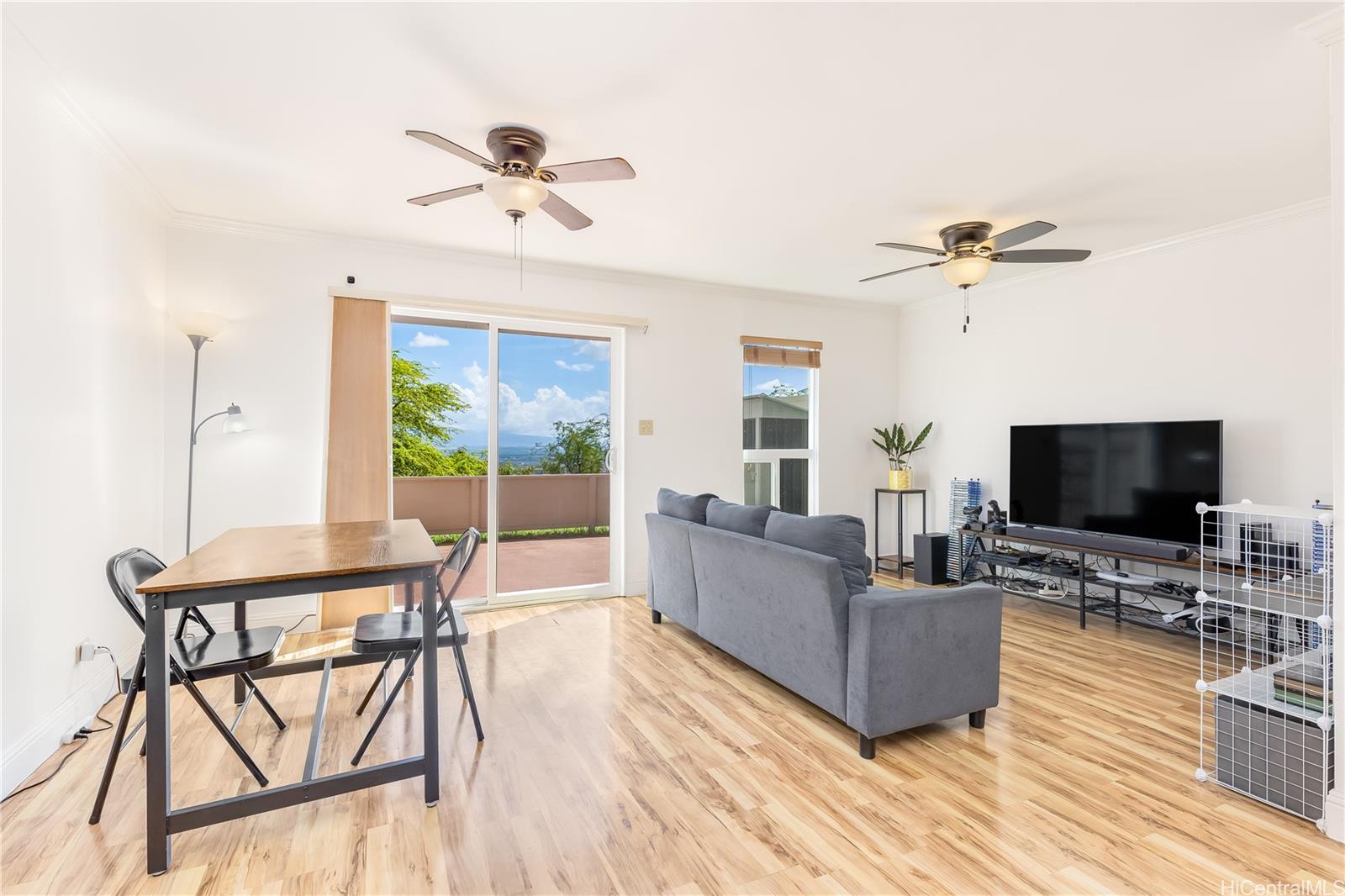 92-787 Makakilo Drive, Unit D28 Kapolei, HI 96707 - Photo 2 of 23 a living room with furniture and a flat screen tv