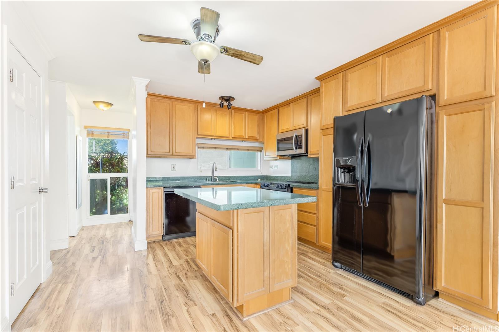 92-787 Makakilo Drive, Unit D28 Kapolei, HI 96707 - Photo 5 of 23 a kitchen with a refrigerator a sink and dishwasher with wooden floor