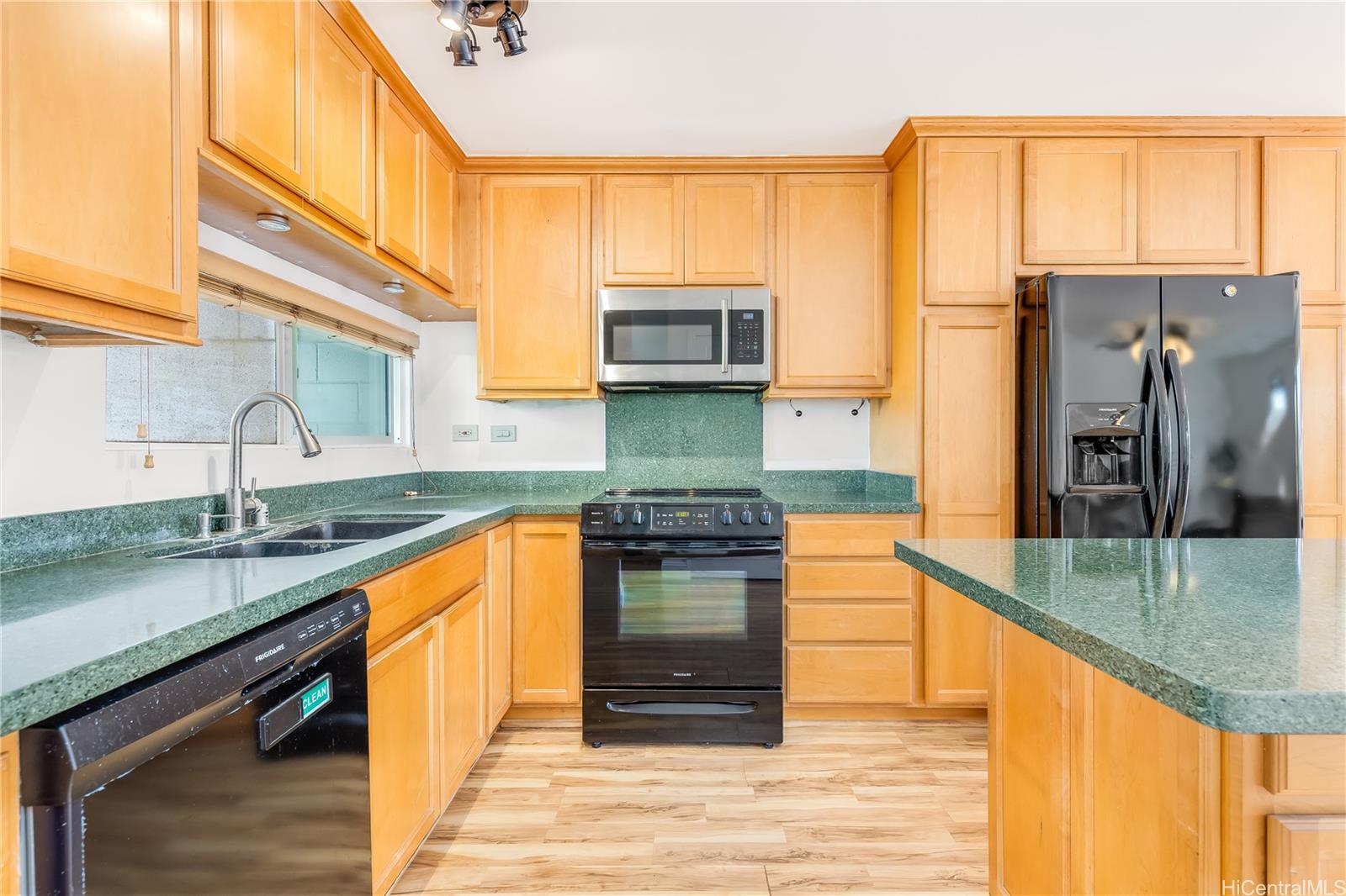 92-787 Makakilo Drive, Unit D28 Kapolei, HI 96707 - Photo 6 of 23 a kitchen with stainless steel appliances granite countertop a sink stove and refrigerator
