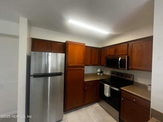 a kitchen with a refrigerator sink and microwave