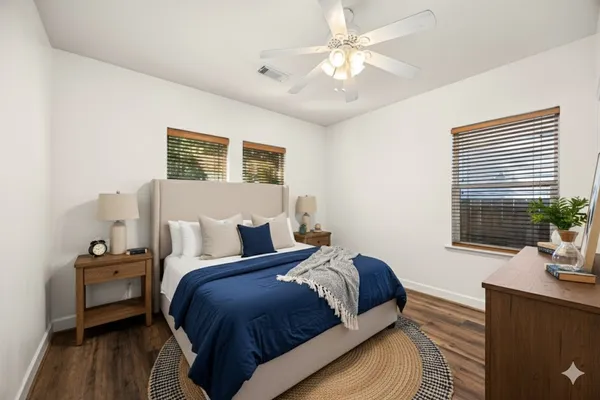 a bedroom with bed and a potted plant