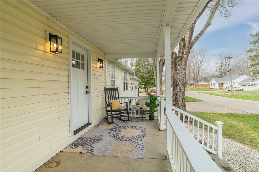 8240 Looney Road Piqua, OH 45356 - Photo 3 of 49 This charming home offers a welcoming porch, perfect for enjoying peaceful neighborhood views.