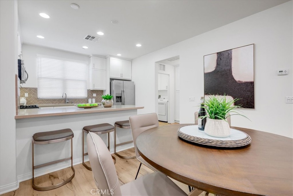 148 Capricorn Irvine, CA 92618 - Photo 12 of 66 a kitchen with a table and chairs in it