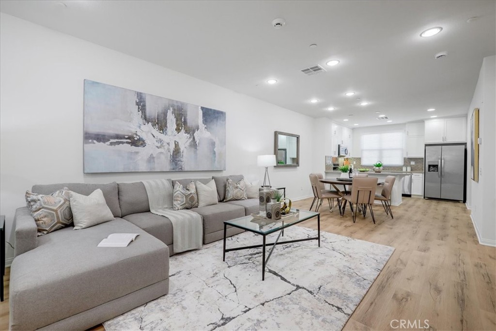 148 Capricorn Irvine, CA 92618 - Photo 24 of 66 a living room with furniture and kitchen view