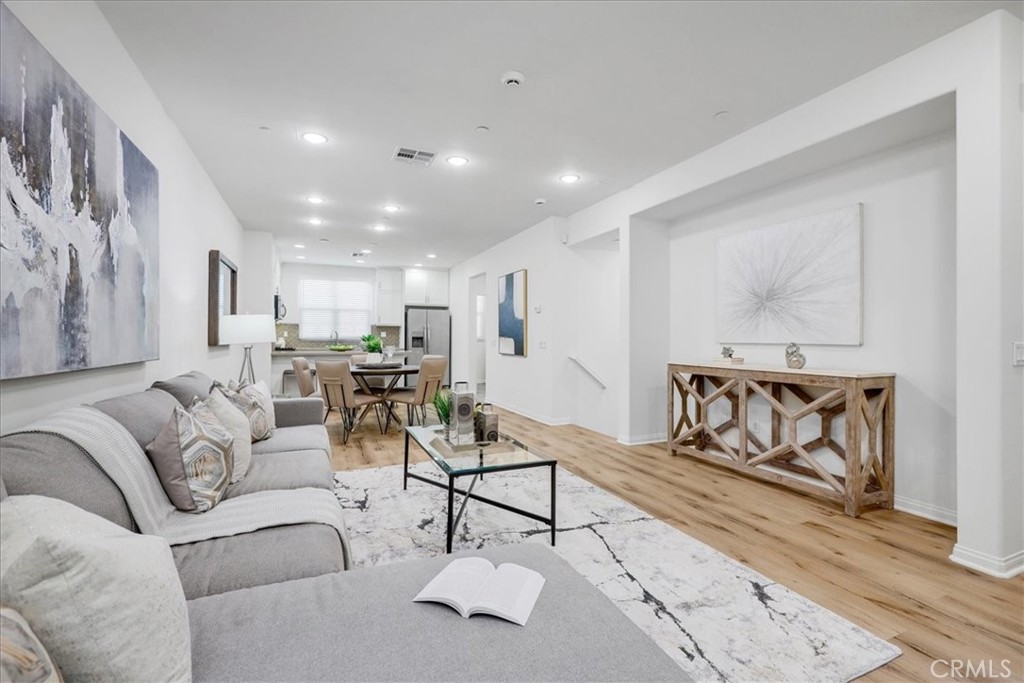 148 Capricorn Irvine, CA 92618 - Photo 29 of 66 a living room with furniture and a painting on the wall