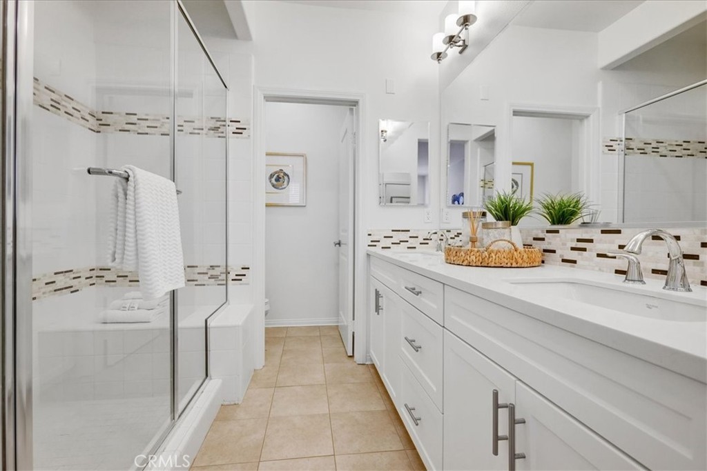 148 Capricorn Irvine, CA 92618 - Photo 44 of 66 a bathroom with a sink a mirror and a shower