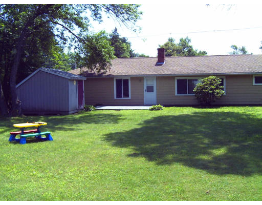 40 Bradford Road Natick, MA 01760 - Photo 3 of 13 a backyard of a house with lots of green space