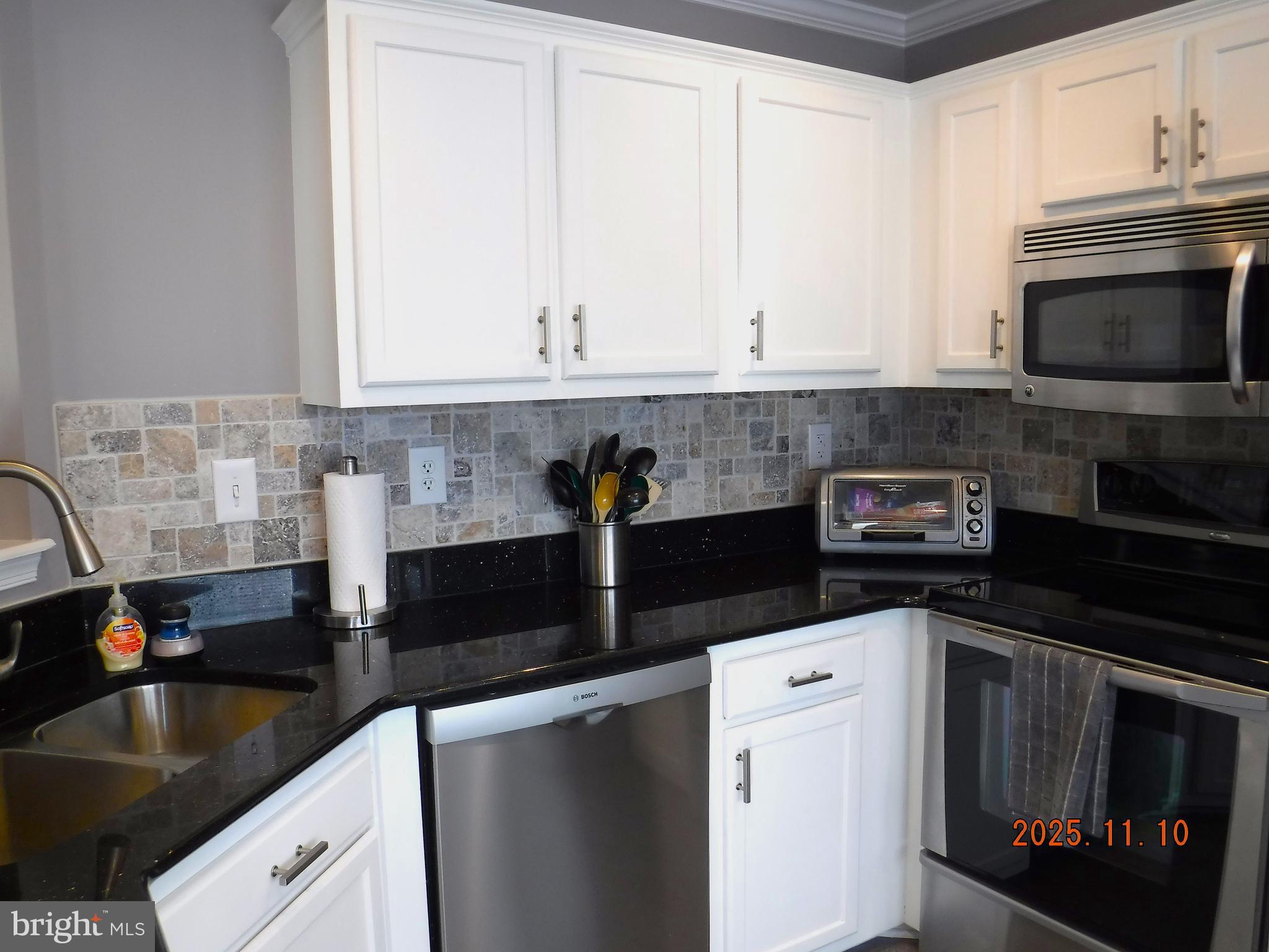 8918 Whitetail Court Perry Hall, MD 21128 - Photo 33 of 64 a kitchen with granite countertop white cabinets and black appliances