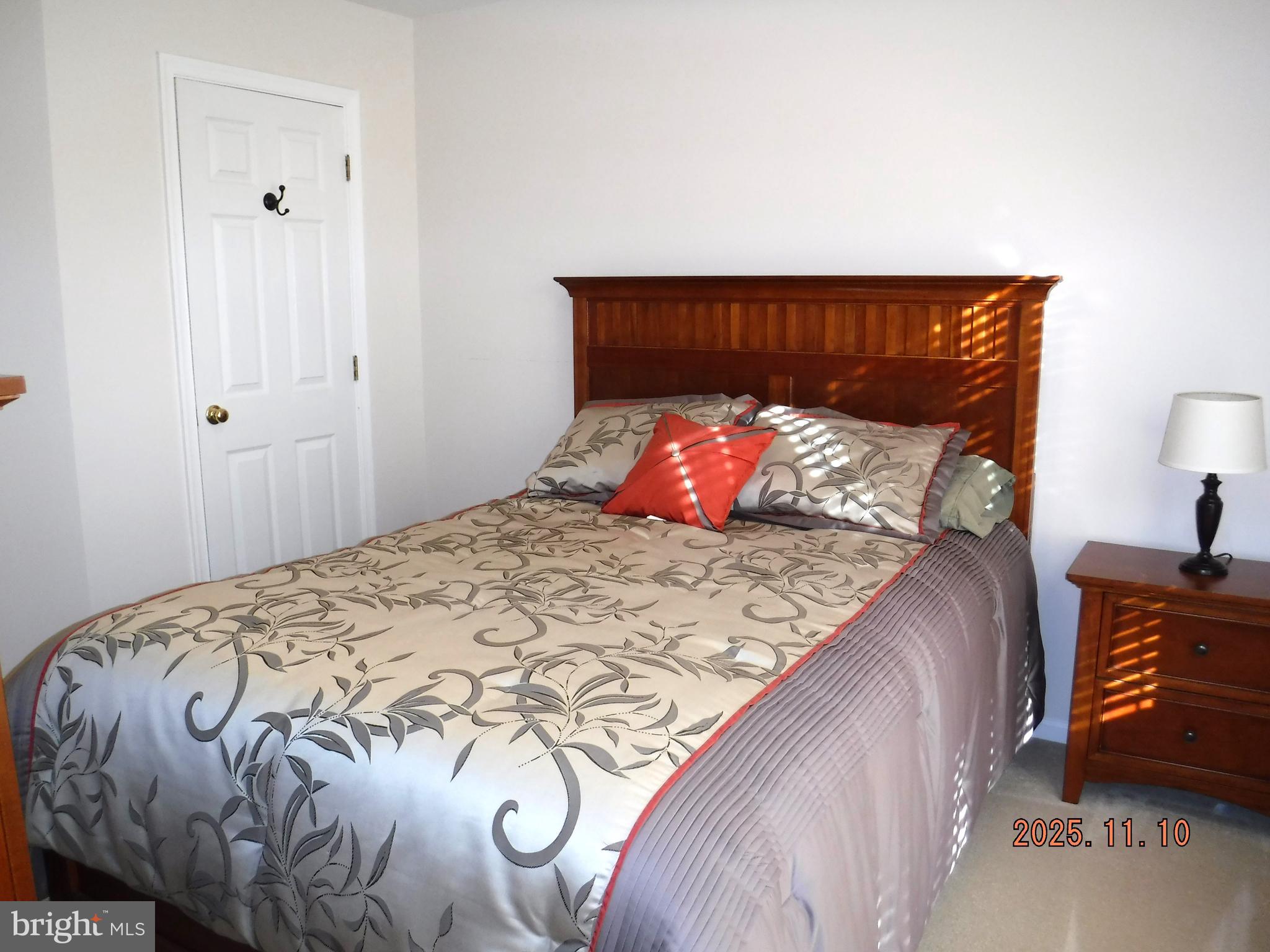 8918 Whitetail Court Perry Hall, MD 21128 - Photo 47 of 64 a bedroom with a bed and a lamp on dresser