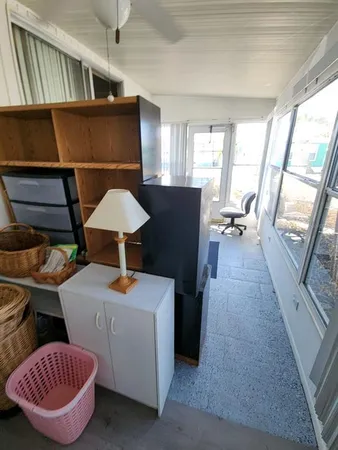a living room with furniture a rug and a window