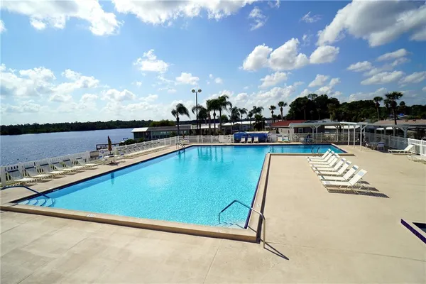 a view of a swimming pool with outdoor seating