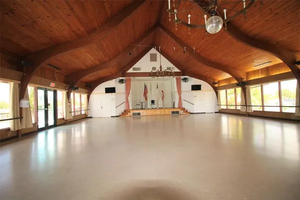 a view of a livingroom with wooden floor and window