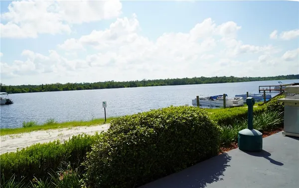 a view of a lake with houses in back